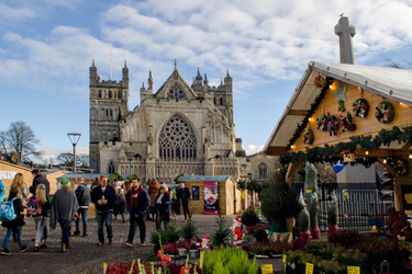 Exeter Cathedral with people and a stall