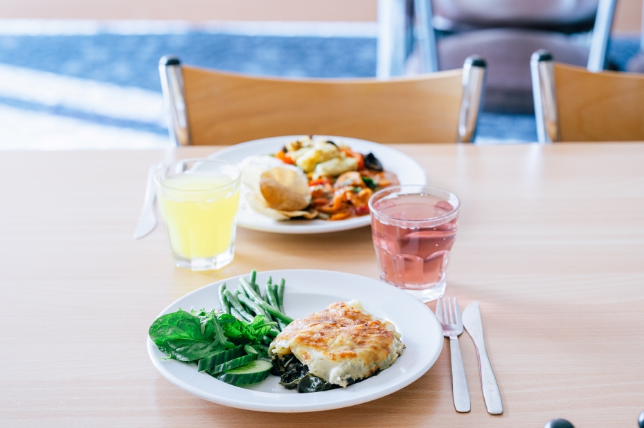 Two plates of food from Holland Hall. Lasagne with green beans and cucumber, and a orange curry with extra cauliflower, mushrooms and white rice