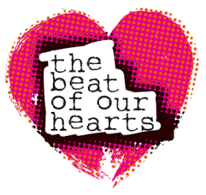 A pink heart overlaid with orange dots. In the centre, typewriter text reads 'the beat of our hearts'.