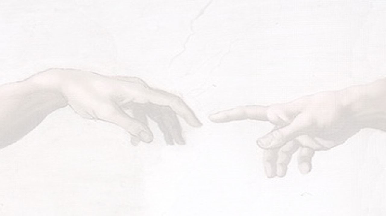 A closeup of two hands from the Sistine Chapel painting