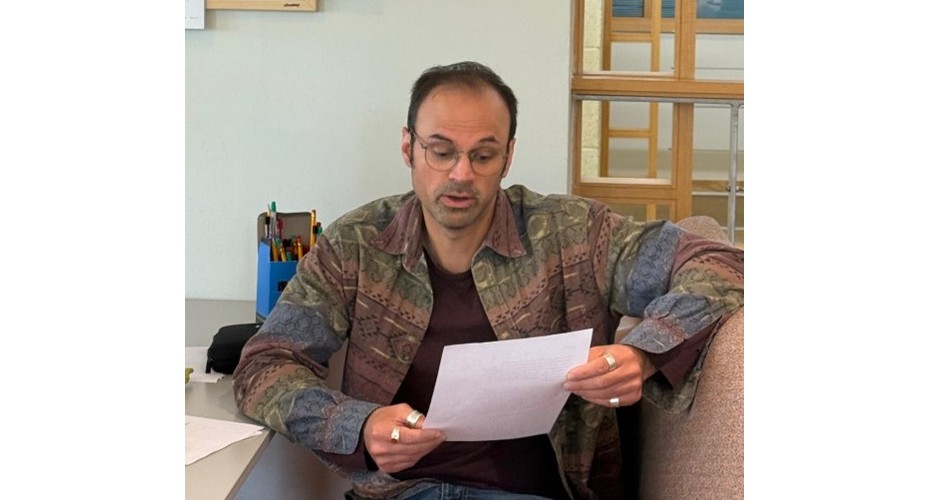 Imran Ahmad reads a message from Professor Ilan Pappe, who could not attend.