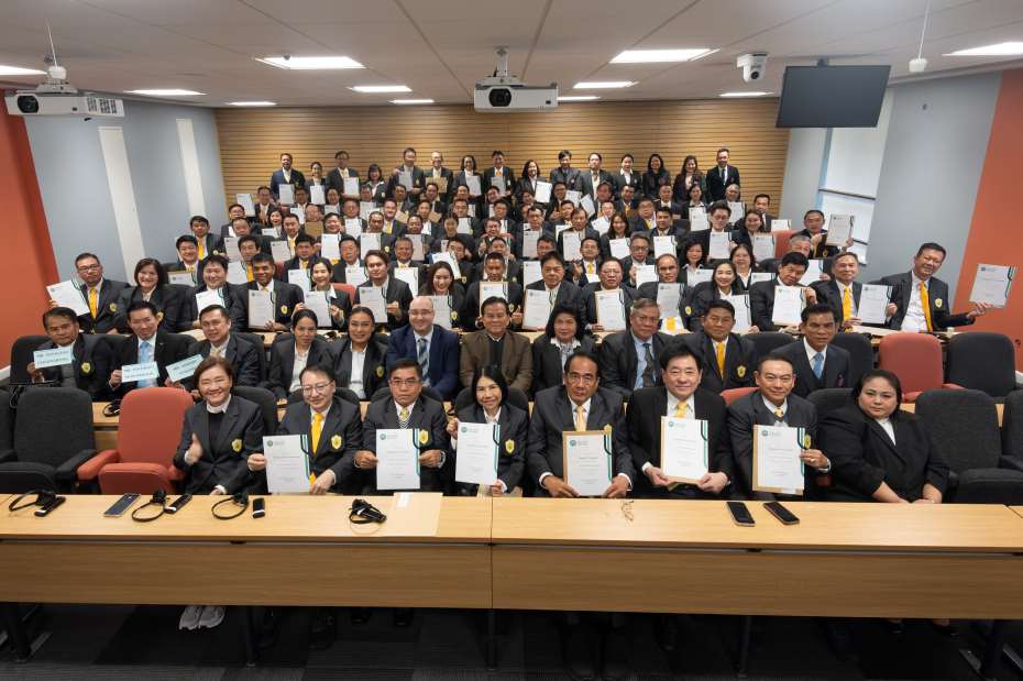 The whole of the group from Thailand sat in the lecture theatre holding their certifcates. 