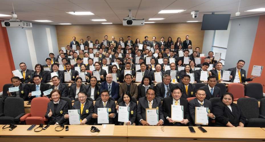The whole of the group from Thailand sat in the lecture theatre holding their certifcates.