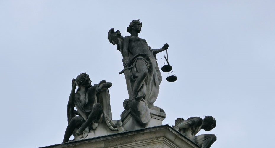A representation of the scales of justice on top of a building