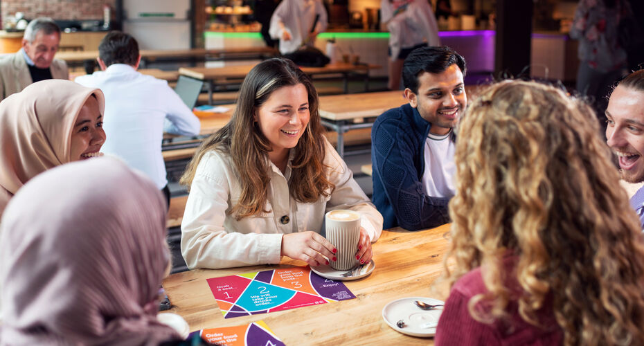 Students sat in the Forum Kitchen around a long table chatting with each other