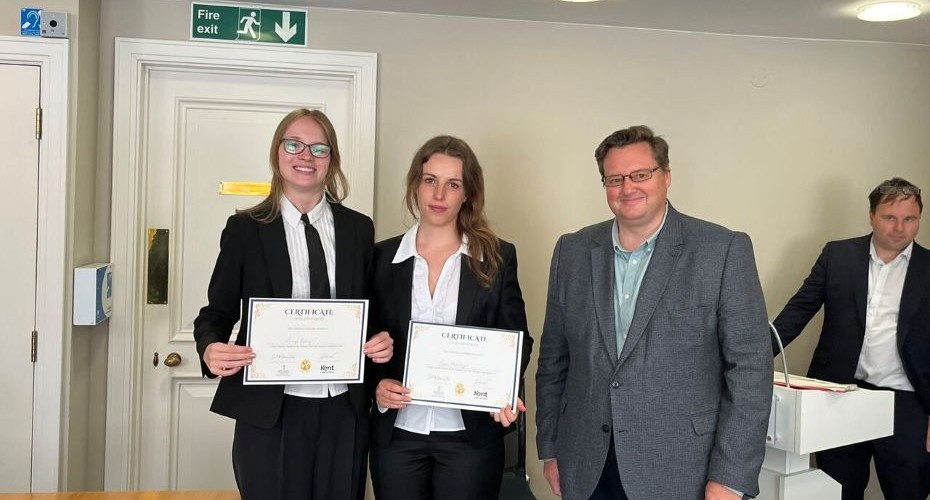 2 students and a judge after competing in a Mooting competition