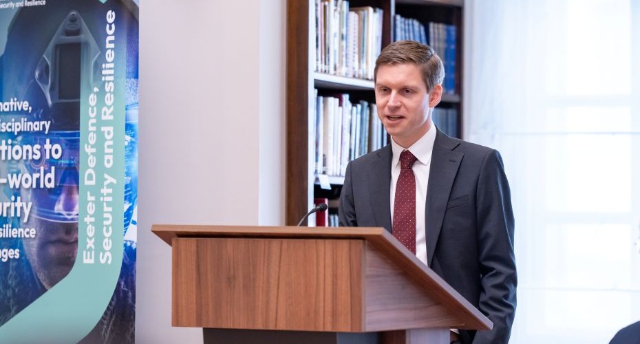 Professor Macak at a lecturn during a talk