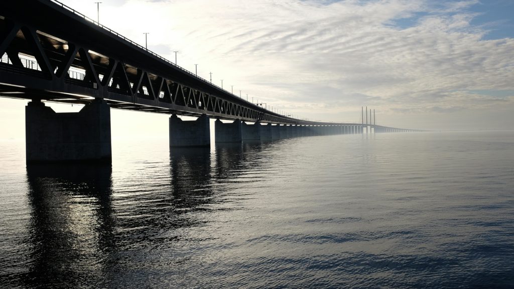 A bridge stretching into the distance over water.