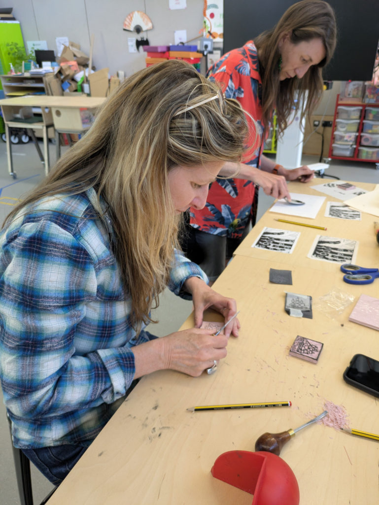 Two women using printing techniques.