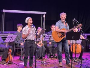 A group of performers standing on stage
