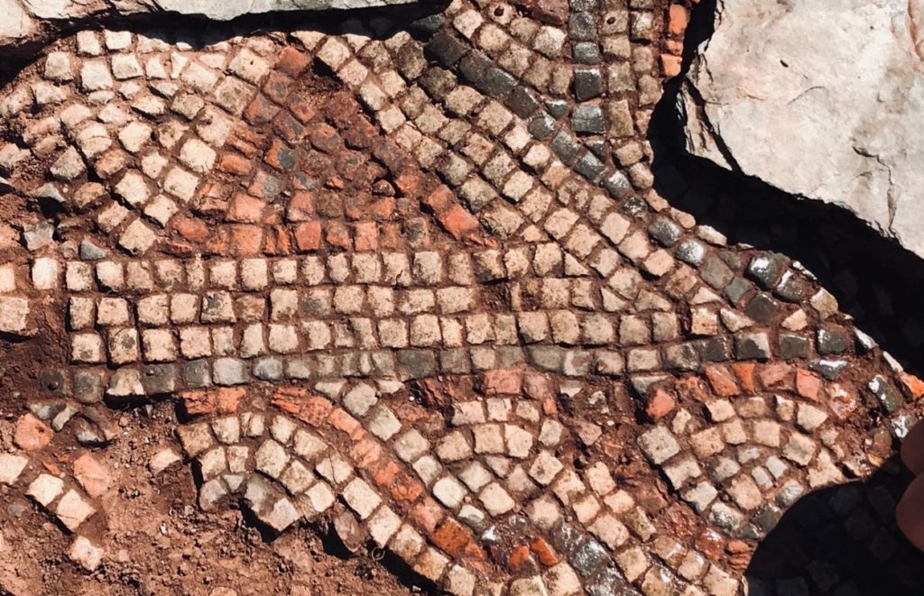Close-up photograph of a multi-coloured mosaic, with an intricate geometric pattern