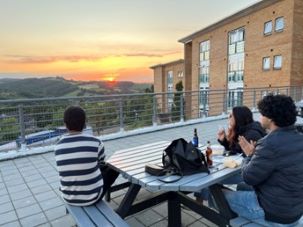 Students watching the sunset over the hills