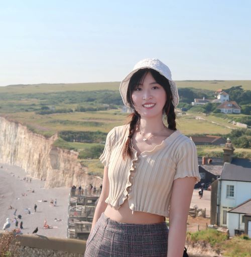 Student in front of a picturesque British beach