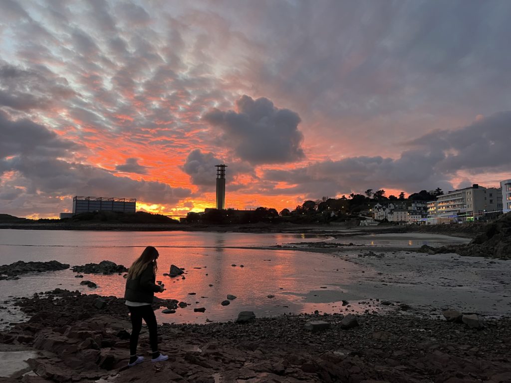 Katie rock pooling in Havre des Pas as the sun goes down  