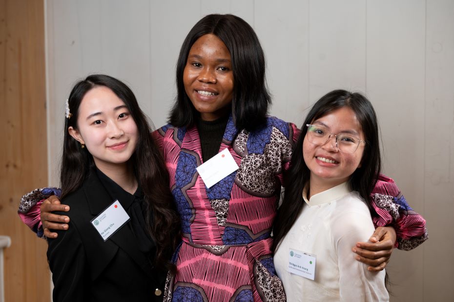 Three smiling students from the University of Exeter at the Global Scholars Reception event