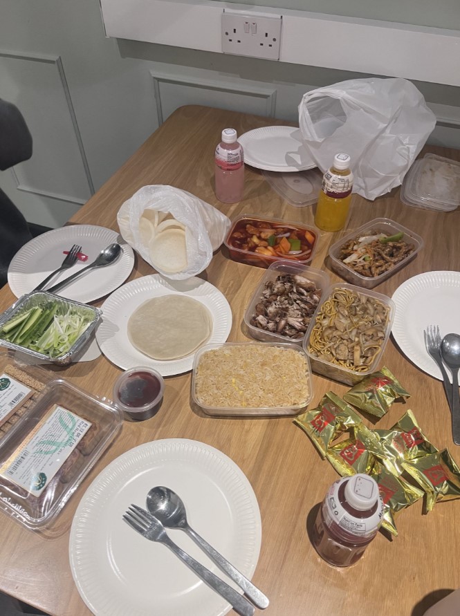 Table covered with Chinese takeaway dishes