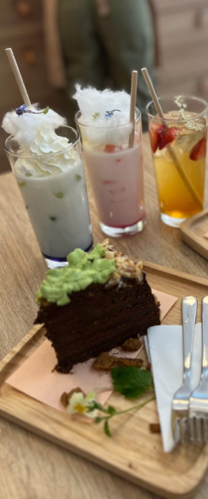 A slice of decorated chocolate cake and a selection of iced drinks