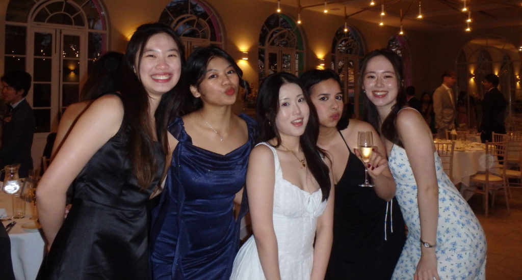 A group of female students dressed up for a formal society event