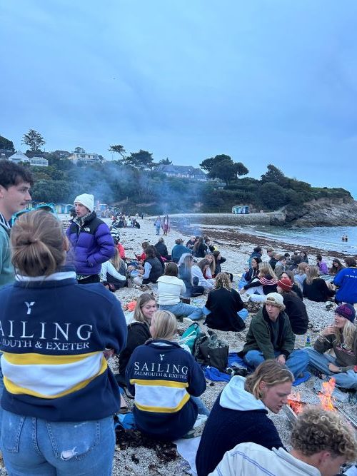 Students having a BBQ on the beach