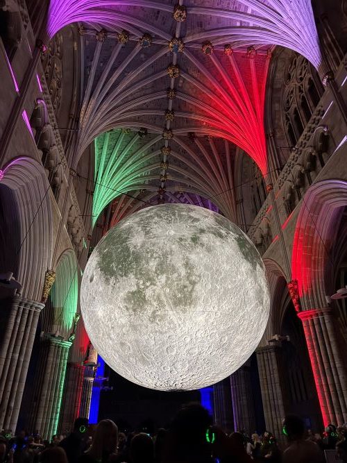 Large moon light decoration inside an Exeter cathedral student event