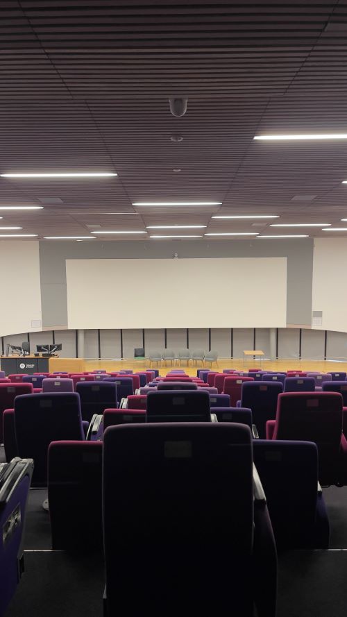 View of an empty lecture theatre taken from behind the seats