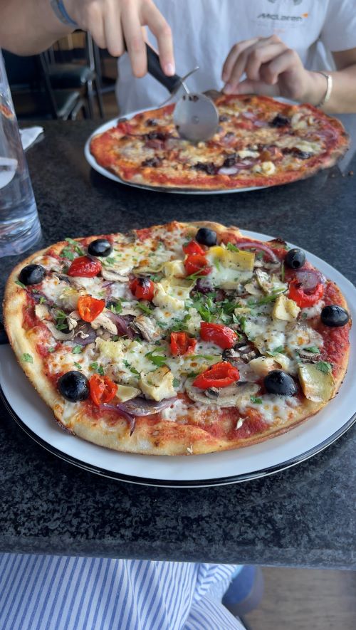 A large pizza topped with lots of vegetables