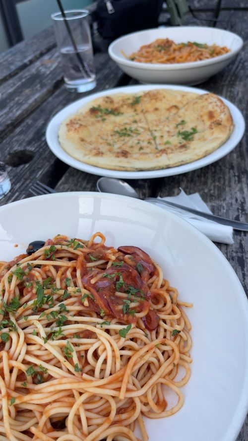 Plates of pasta and garlic bread