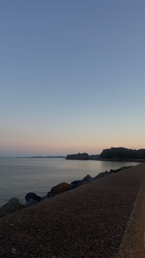 Coastline and a calm sea at sunset