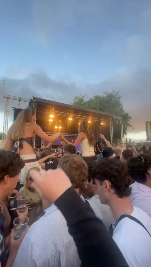Crowd in front of a lit festival stage