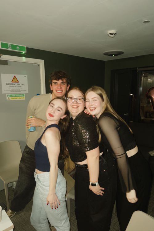 Four students posing together for the camera