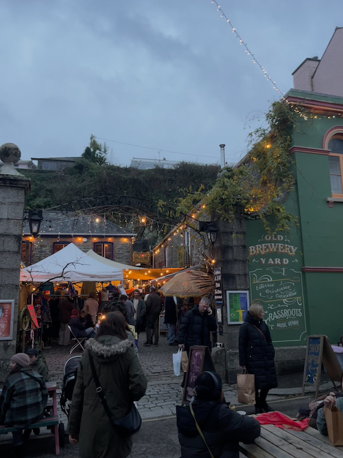 A photo showing Christmas market stalls at the Old Brewery Yard, Falmouth