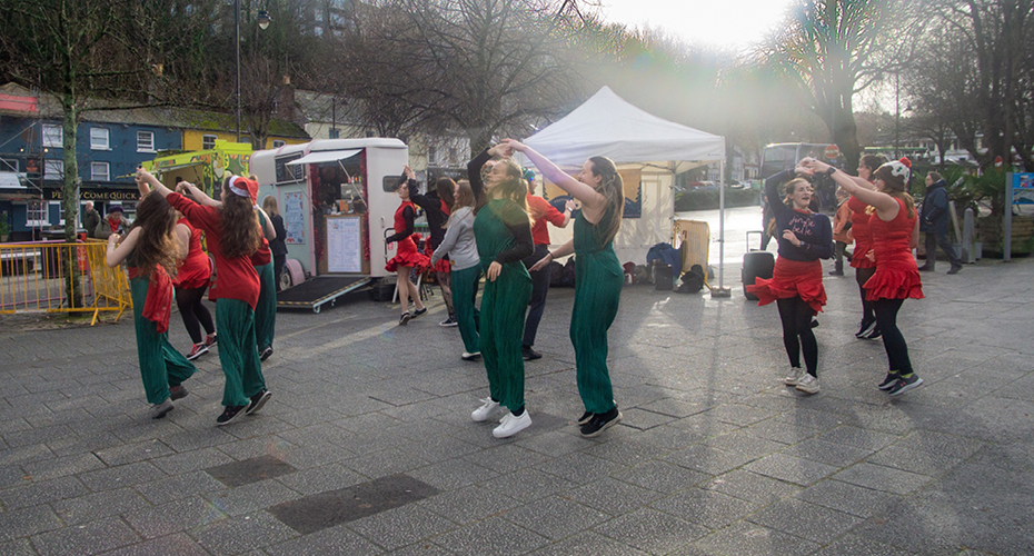 Students performing a festive dance in town