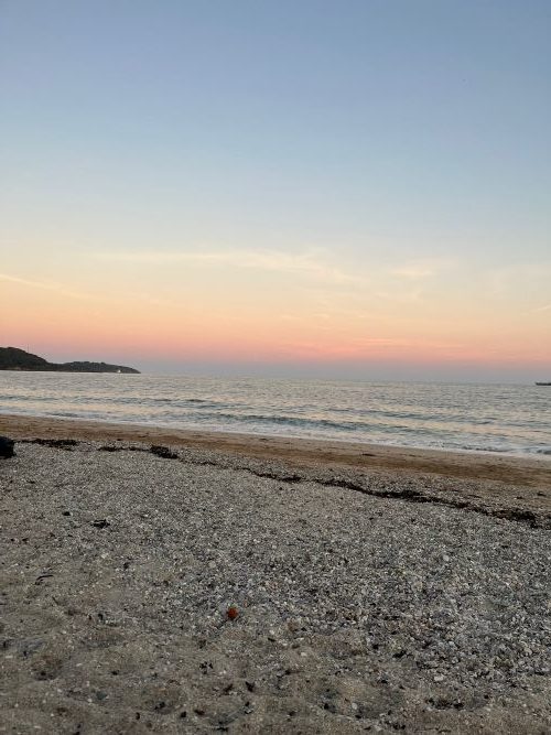 A soft pink and blue sky at Gylly beach before the sun sets.