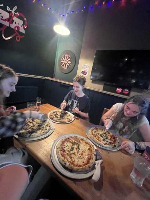 Eating pizza with my friends at Fives Cyderhouse in Falmouth town.