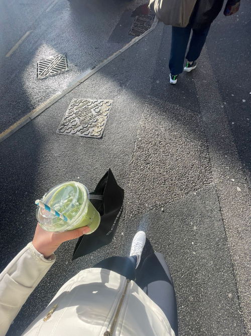 A student carrying an iced matcha