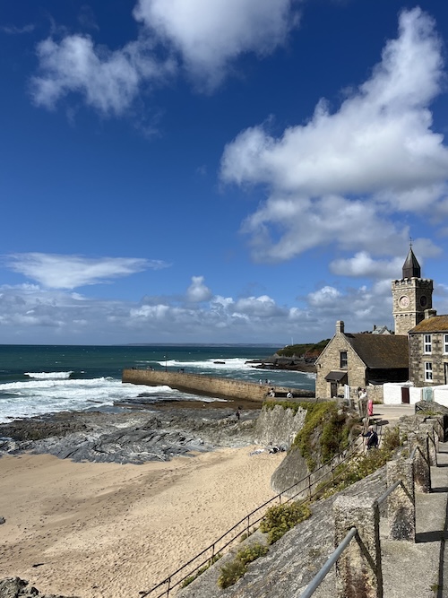 The beach and church of Porthleven with blue sky
