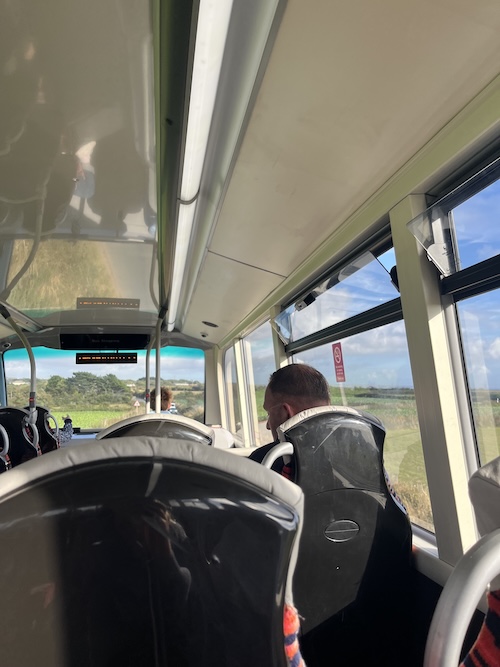 The inside of a bus with nice views of countryside through the windows