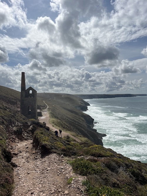 The coast path for the walk to St Agnes, with dramatic sea and historic mine building