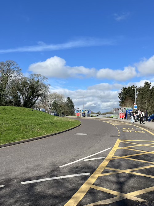 The main bus stops on campus on a sunny day