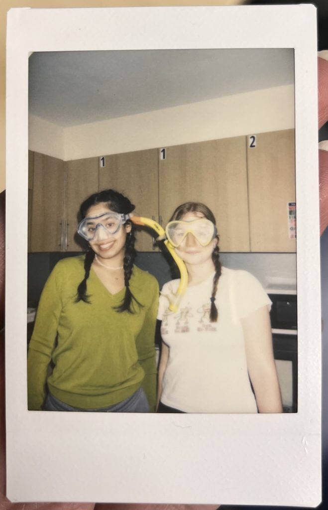 Polaroid of a friend and I gettting ready to go to the beach, taken in Glasney Halls kitchen.