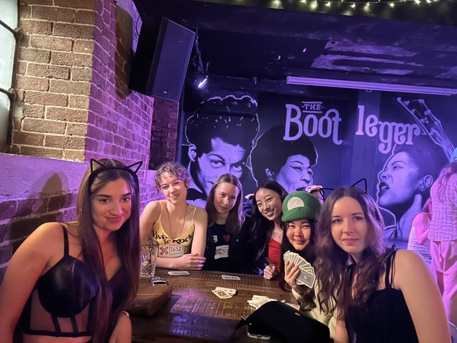A group of us playing a card game at the Bootlegger bar during a Psychology Social.