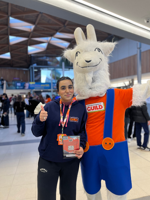 Reeham stood next to the Students' Guild mascot in the Forum building.