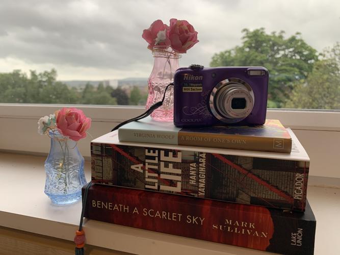 My camera and a stack of books that I brought to uni to fill my spare time.