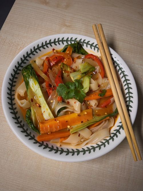 Bowl of Thai noodle soup with chopsticks.