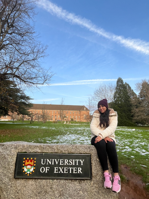 Reeham sat on a large rock on campus which features the university name and crest logo.