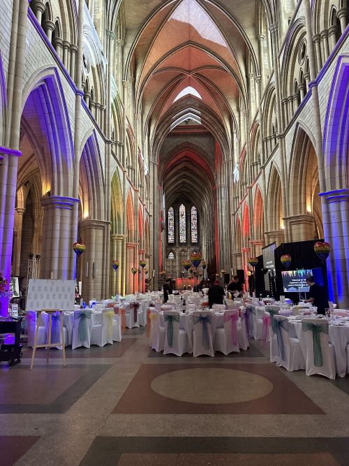 Tables set up for a formal dinner in Truro Cathedral