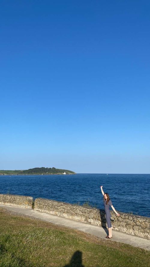 Female student next to the sea on a sunny day