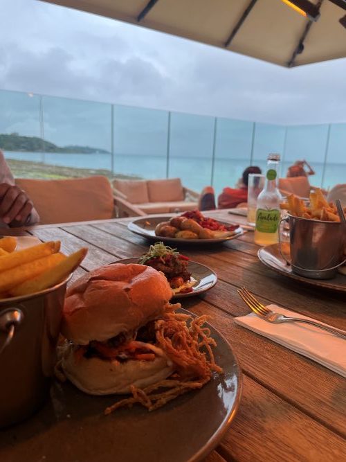 food at Gylly Beach Cafe- burgers and chips, with beach view at the back