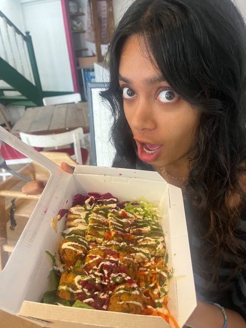 My sister holding a falafel salad box at Chicpea