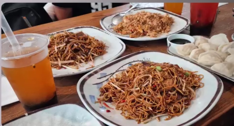Several plates of Chinese food